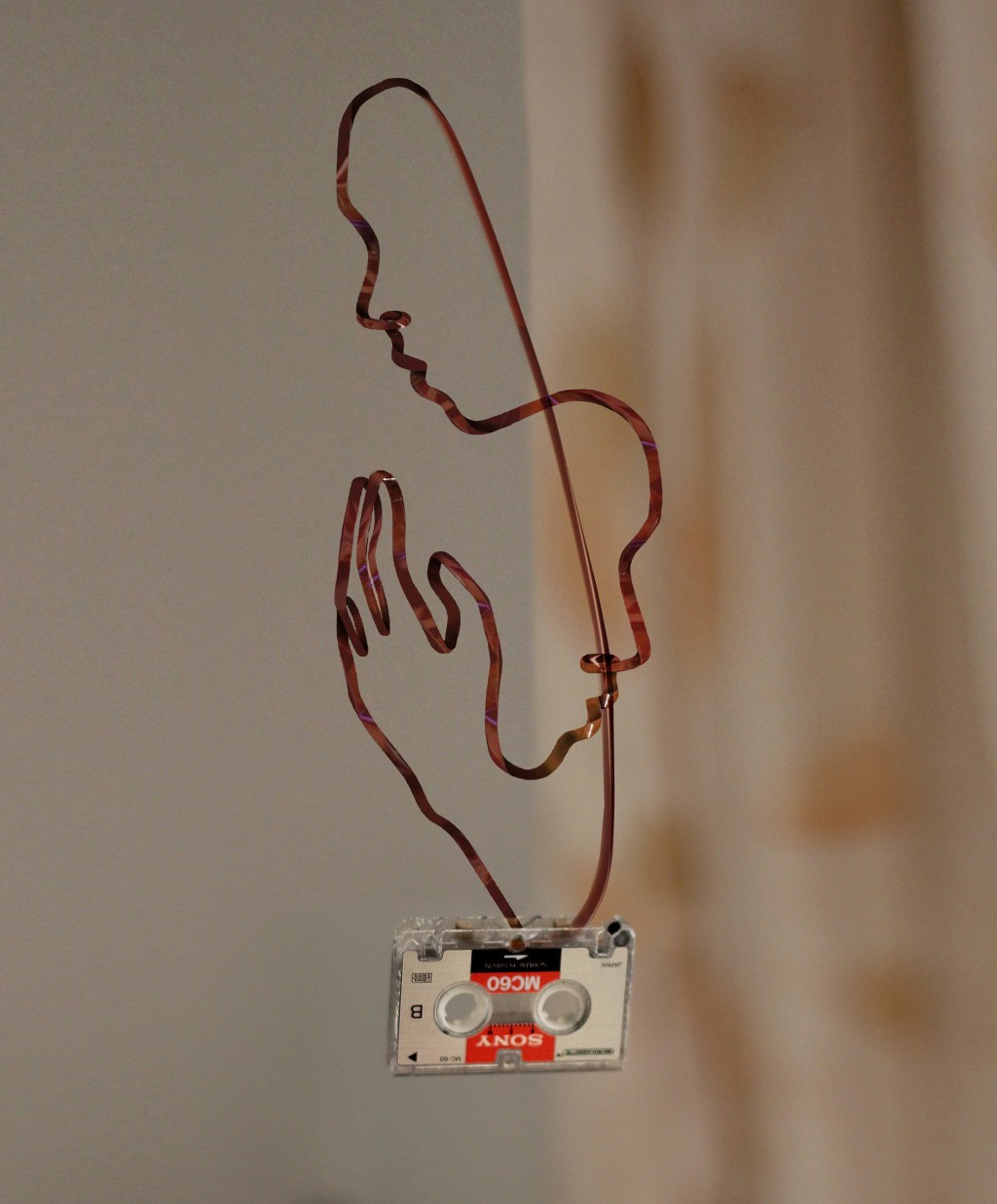 Hug artwork created with an audio cassette tape ribbon